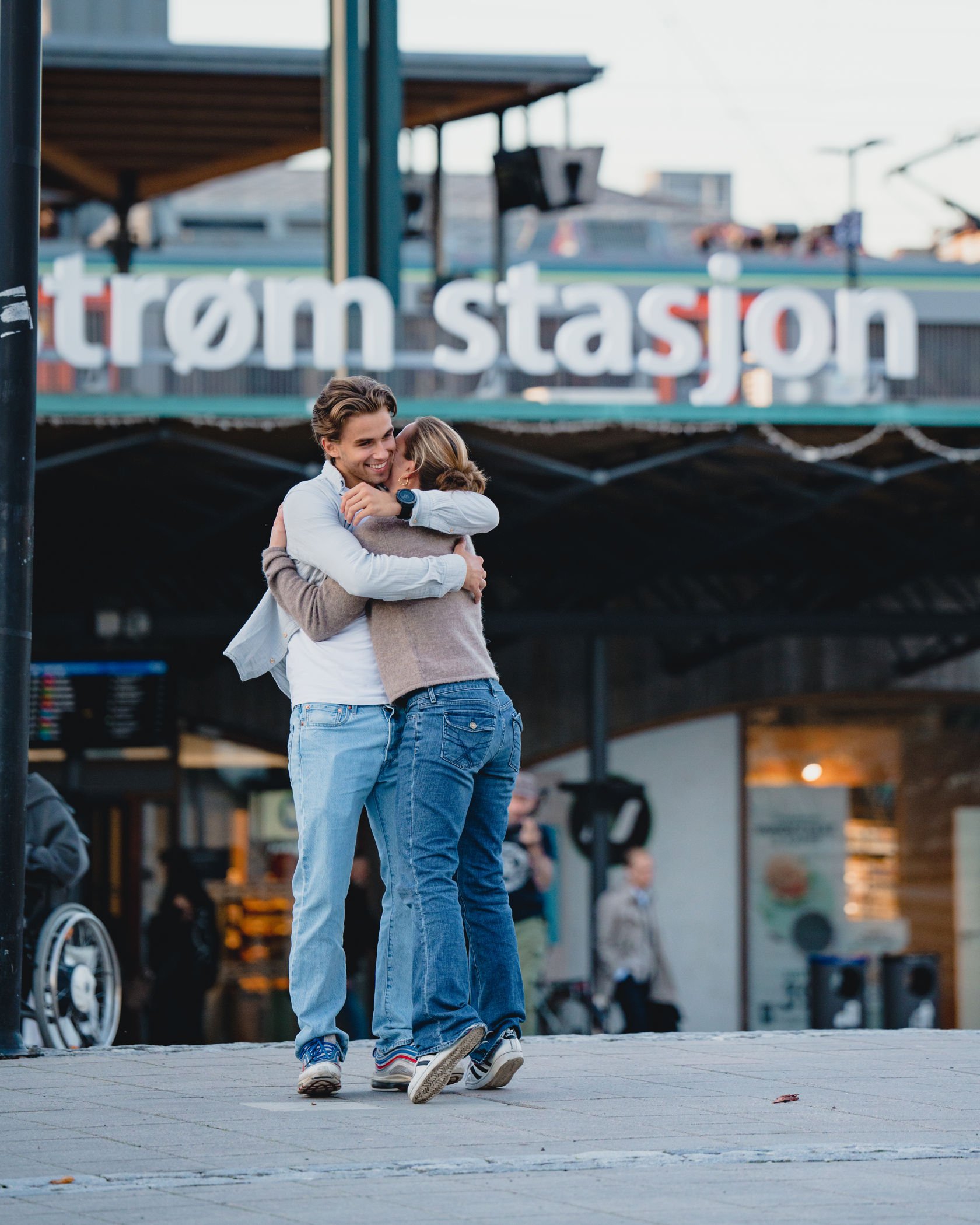 Gutt og jente klemmer foran Lillestrøm stasjon